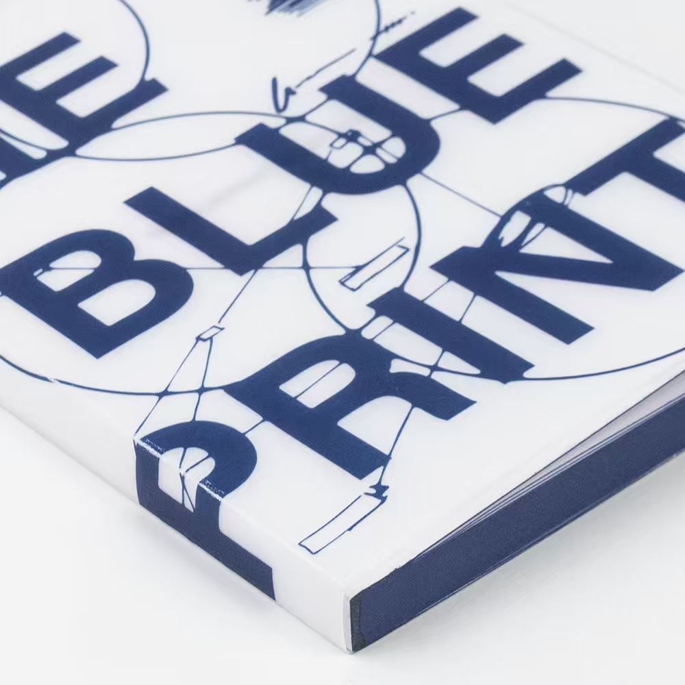 Book titled 'The Blueprint' with architectural design elements on a white background